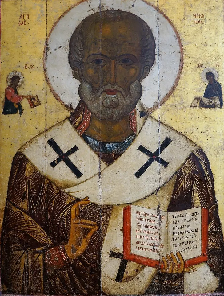 Russian icon of St. Nicholas as a gray-bearded bishop with a white omophorion marked with black crosses, blessing with one hand and holding an open Gospel book
