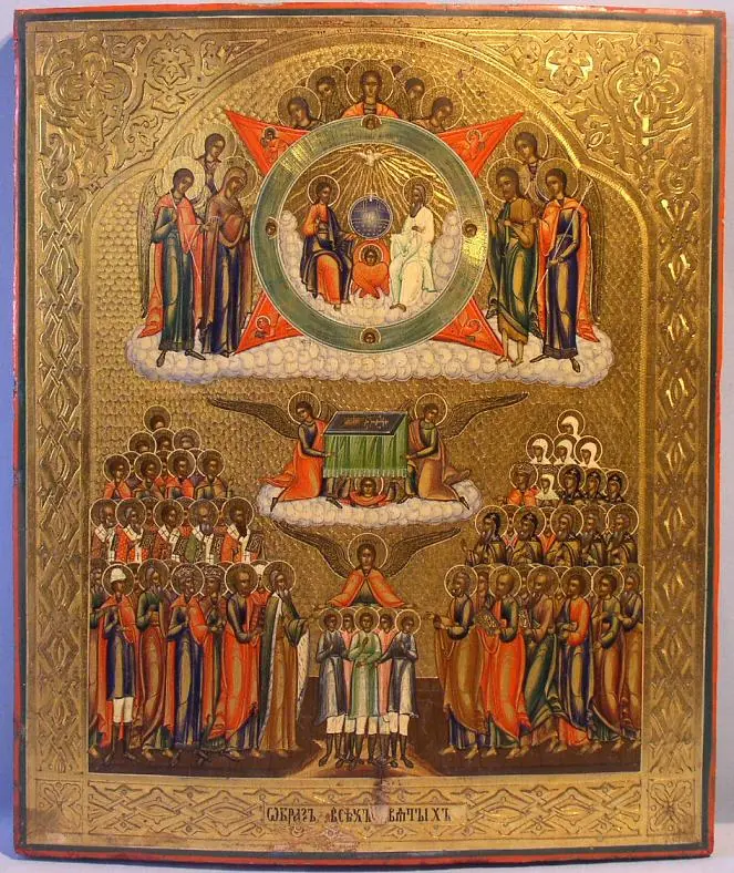 Russian icon on a gold ground with the Holy Trinity in a circle at the top and many rows of saints below, gathered around an altar