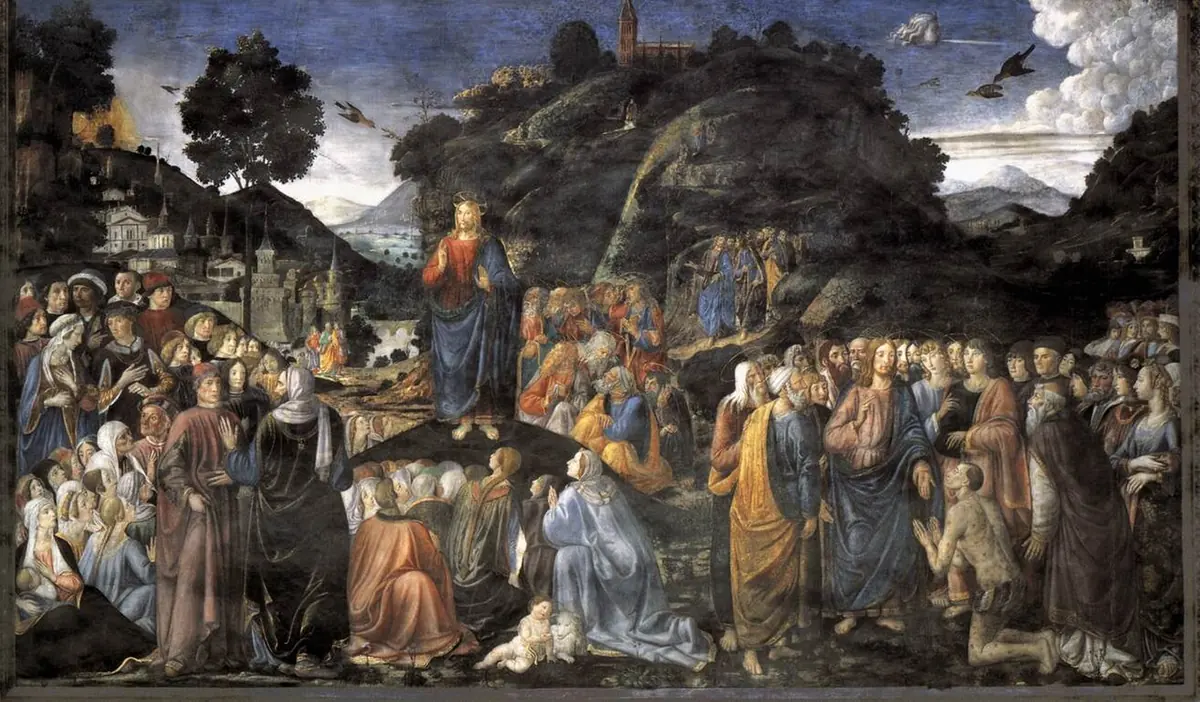 Wide Renaissance fresco of Christ preaching from a small rise to a great crowd in colorful fifteenth-century dress, with hills and a town in the distance and a healing scene at the right