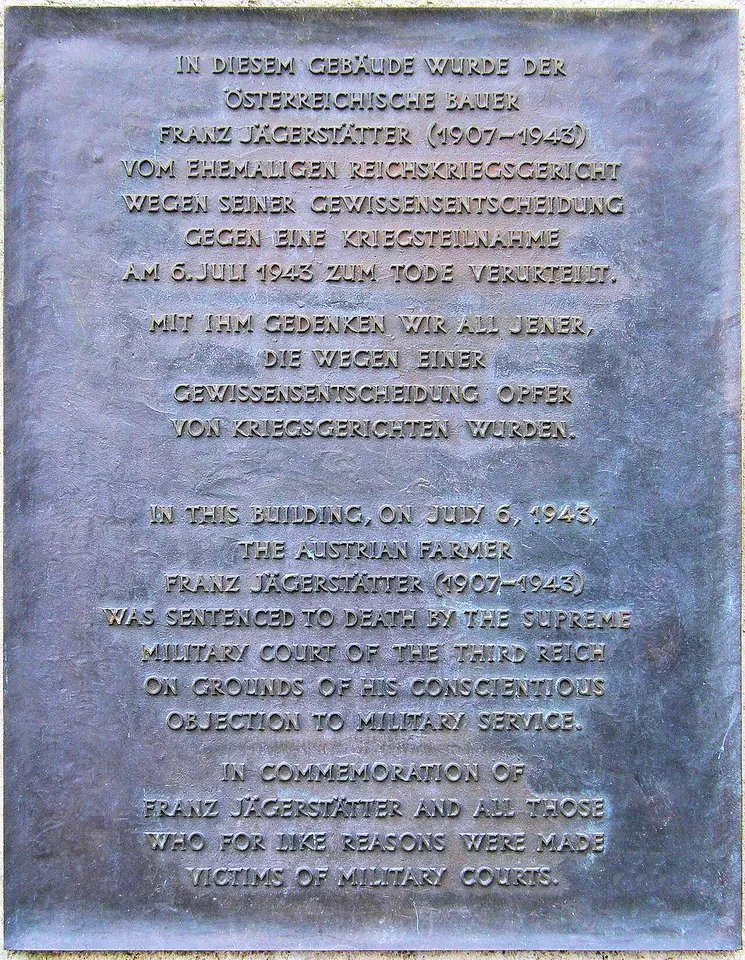 Bronze plaque with text in German and English recording that Franz Jägerstätter was sentenced to death in this building on July 6, 1943