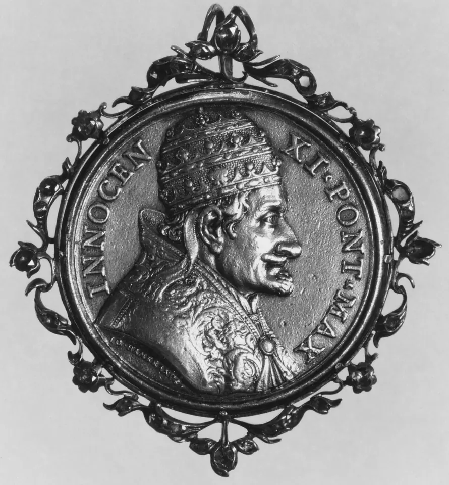 Silver-gray portrait medal of Pope Innocent XI in profile wearing the papal tiara, with the Latin inscription INNOCEN XI PONT MAX, set in an ornate pierced frame