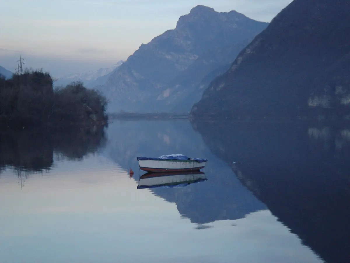 A view over the blue waters of Lake Idro from Anfo, with steep green mountains on both sides
