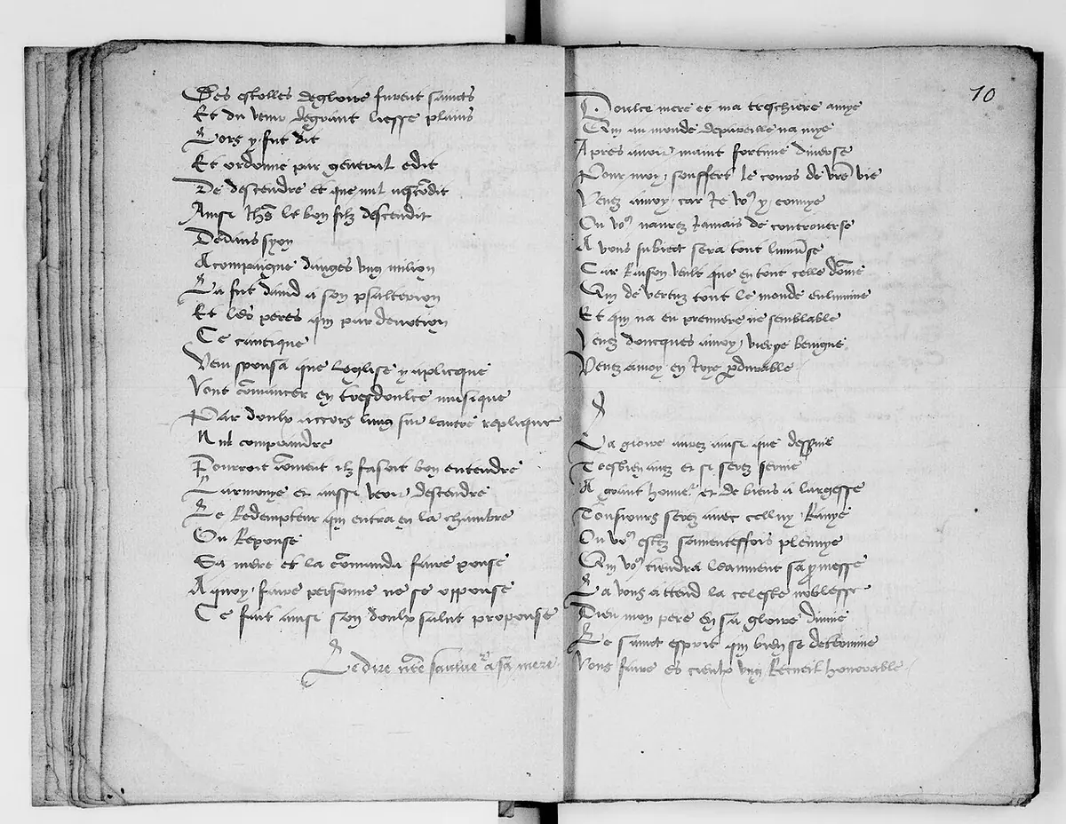 An open handwritten book with two pages of short verse lines in sixteenth-century French script