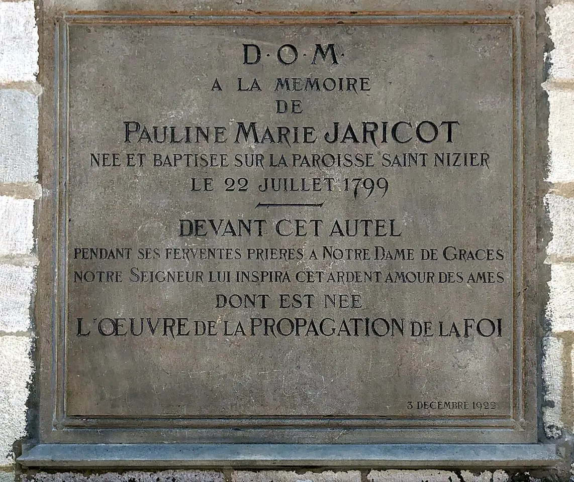Stone plaque in French recording that Pauline Marie Jaricot was born and baptized in the parish of Saint-Nizier and that the work of the Propagation of the Faith was born of her prayers before this altar