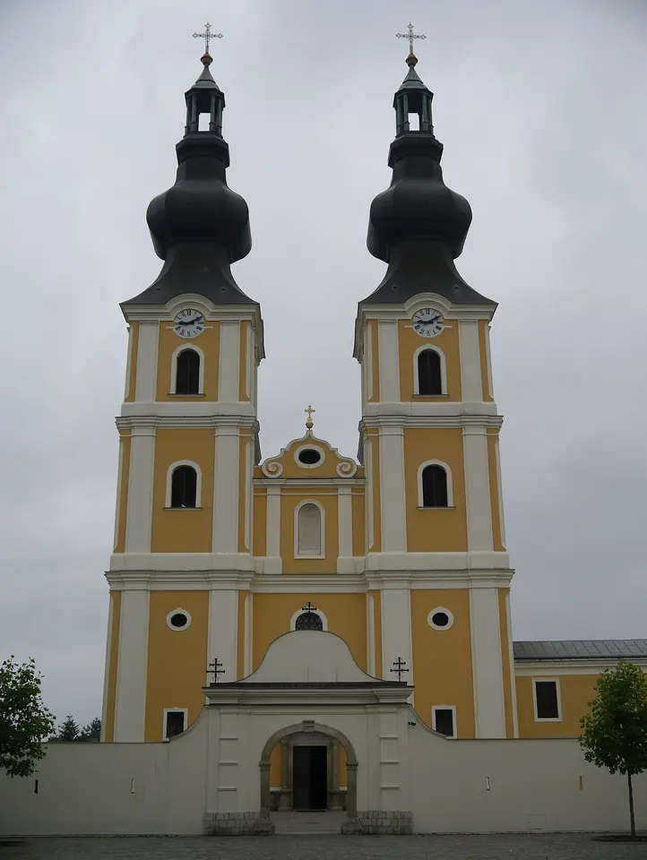 The yellow twin-towered Baroque facade of the Greek Catholic basilica and Marian shrine of Máriapócs in Hungary