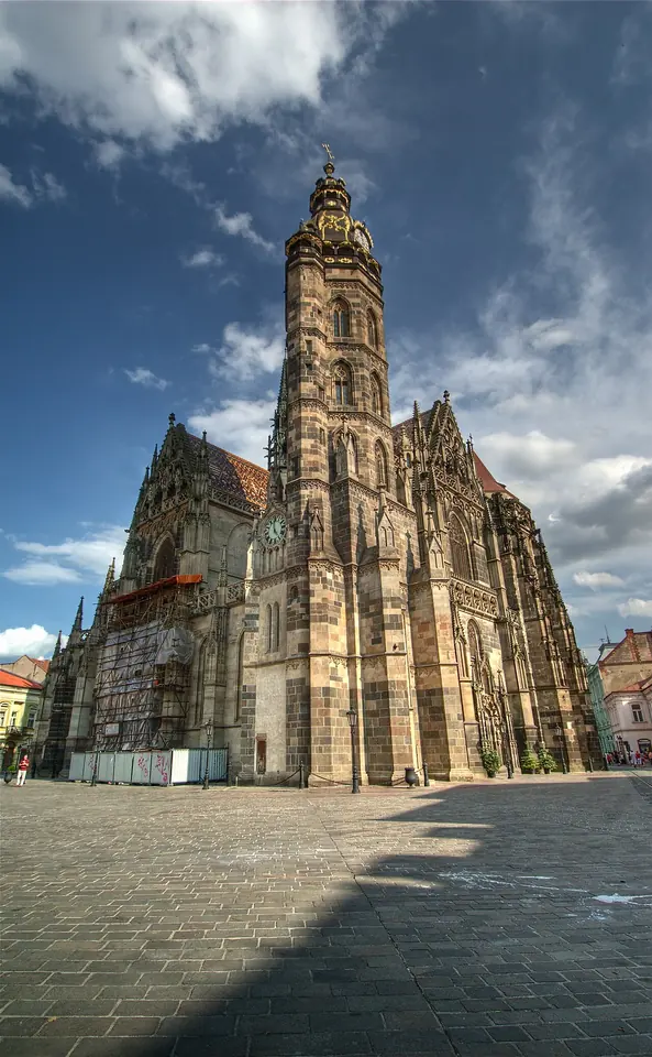 The tall Gothic cathedral of St. Elizabeth in Košice with its north tower and steep patterned roof against a blue sky