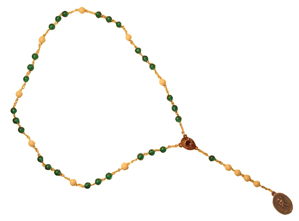 A loop of small green and cream beads arranged in groups, with a short pendant ending in a small oval medal