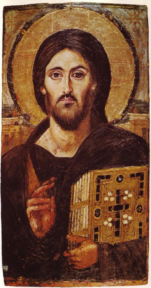 Icono antiguo de Cristo con aureola dorada, barba oscura y cabello largo, que bendice con la mano derecha y sostiene un libro de los Evangelios adornado con piedras preciosas