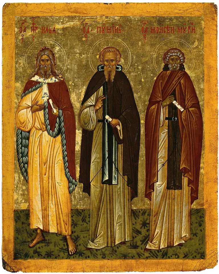 Russian icon on a gold ground of three standing figures, the prophet Elijah in a red cloak, Abba Poimen in a dark habit, and Moses the Black in a brown habit holding a scroll