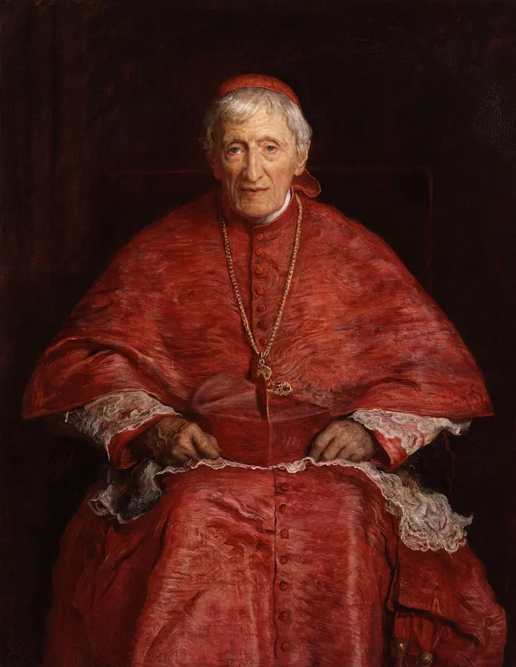 Elderly cardinal with white hair in red choir dress and red skullcap, seated with his hands folded on his lap