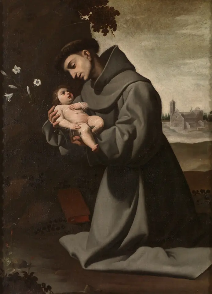 Lienzo de Zurbarán de San Antonio con hábito franciscano gris, arrodillado en un paisaje, que sostiene con ternura al Niño Jesús en brazos, con un lirio a un lado y un libro rojo en el suelo