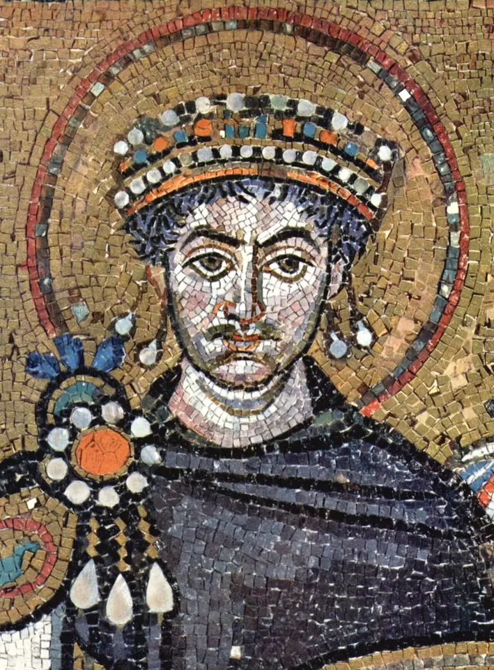 Mosaic head of a young man with a jeweled crown and a purple cloak with a gold brooch, framed by a large gold halo with a red rim