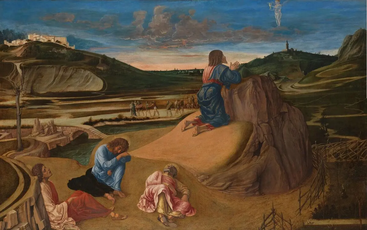 Jesus kneels in prayer on a rocky outcrop at dawn while three apostles sleep below him and a small angel appears in the sky, with a hill town and a wide valley behind