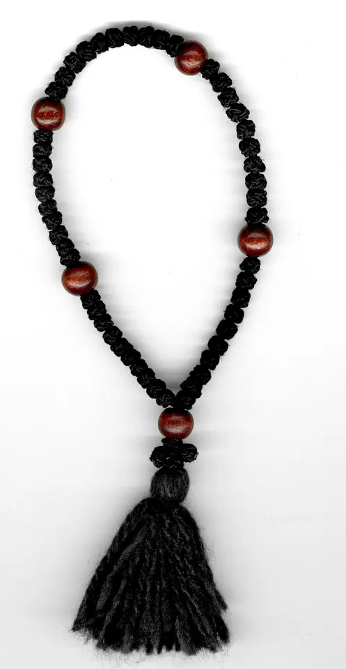 Short black knotted prayer rope divided by round reddish-brown wooden beads, ending in a black tassel
