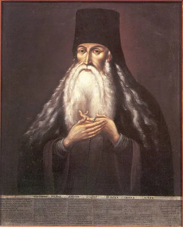 Painted portrait of an old monk with a long white beard and a dark hood, his hands held together in front of his chest
