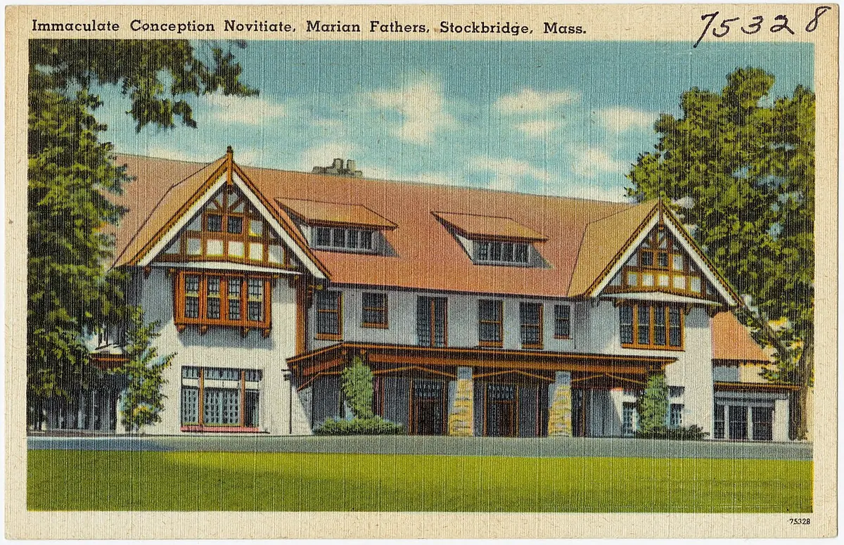 Old color postcard of a large Tudor-style mansion with half-timbered gables and a long green lawn, captioned Immaculate Conception Novitiate, Marian Fathers, Stockbridge, Mass.