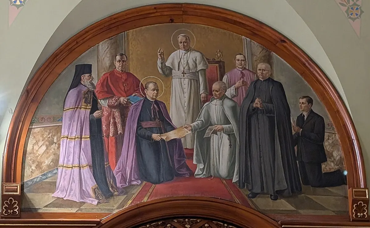 A half-moon mural of an old priest in a white habit handing a document to a bishop in purple, while a pope in white and cardinals in red look on