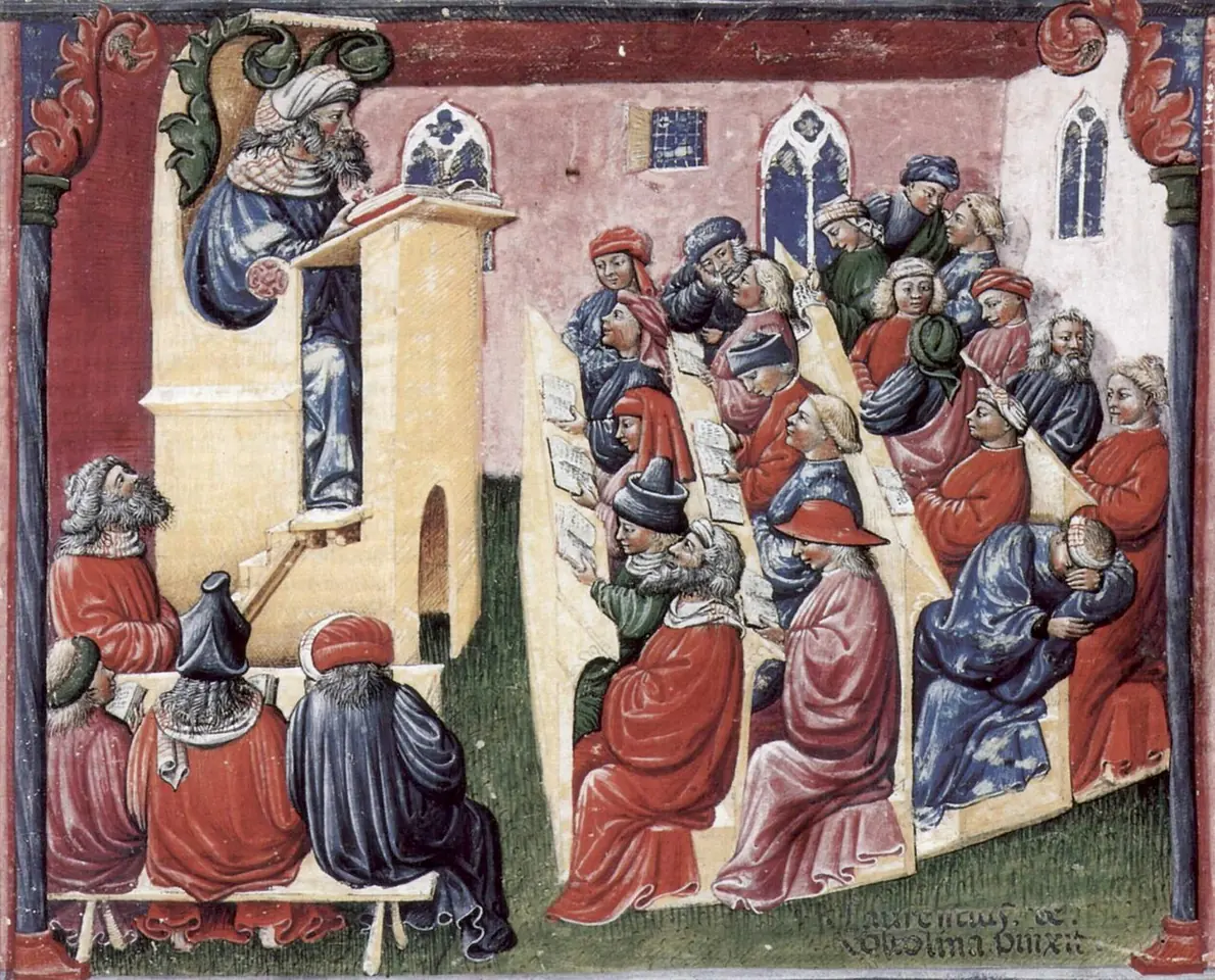 Medieval miniature of a teacher at a raised lectern reading to rows of students in red and blue robes, some listening, some whispering, one asleep