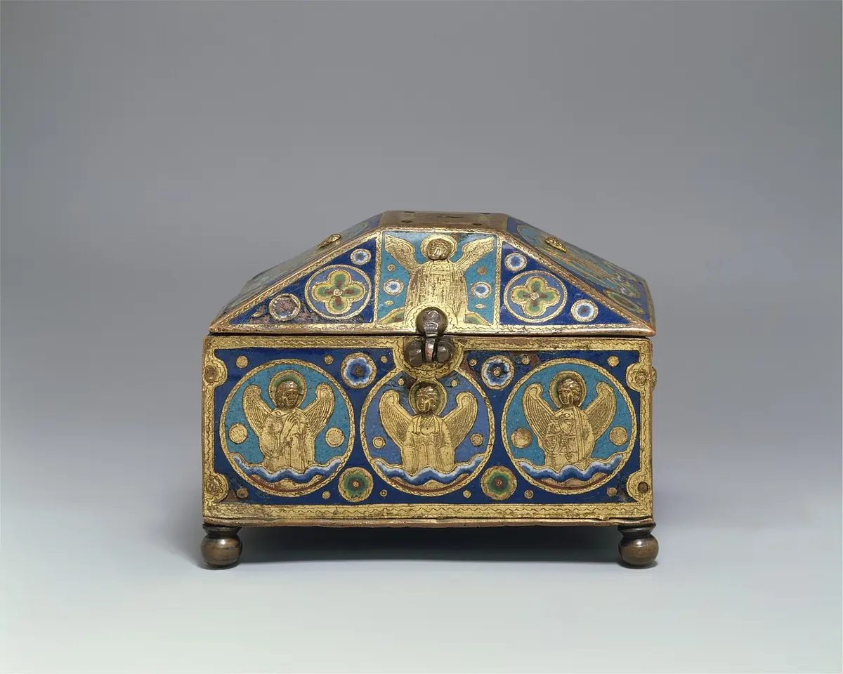 A small house-shaped box of gilt copper decorated with blue enamel and engraved angels in roundels, made to hold the vials of holy oils