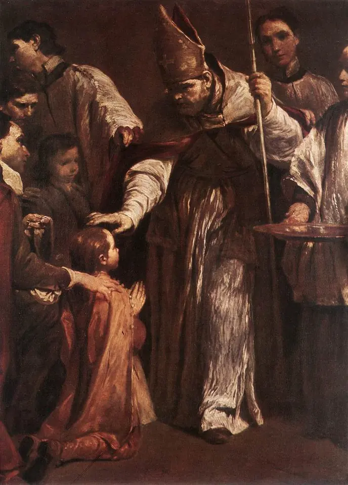 A bishop in a tall miter reaches out to anoint a small boy who kneels before him, with a sponsor's hand on the boy's shoulder and clergy standing around