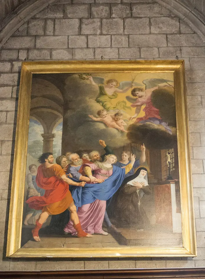 Gilt-framed painting of men in colorful robes pulling at a young woman while a nun prays at an altar and angels look down from the clouds