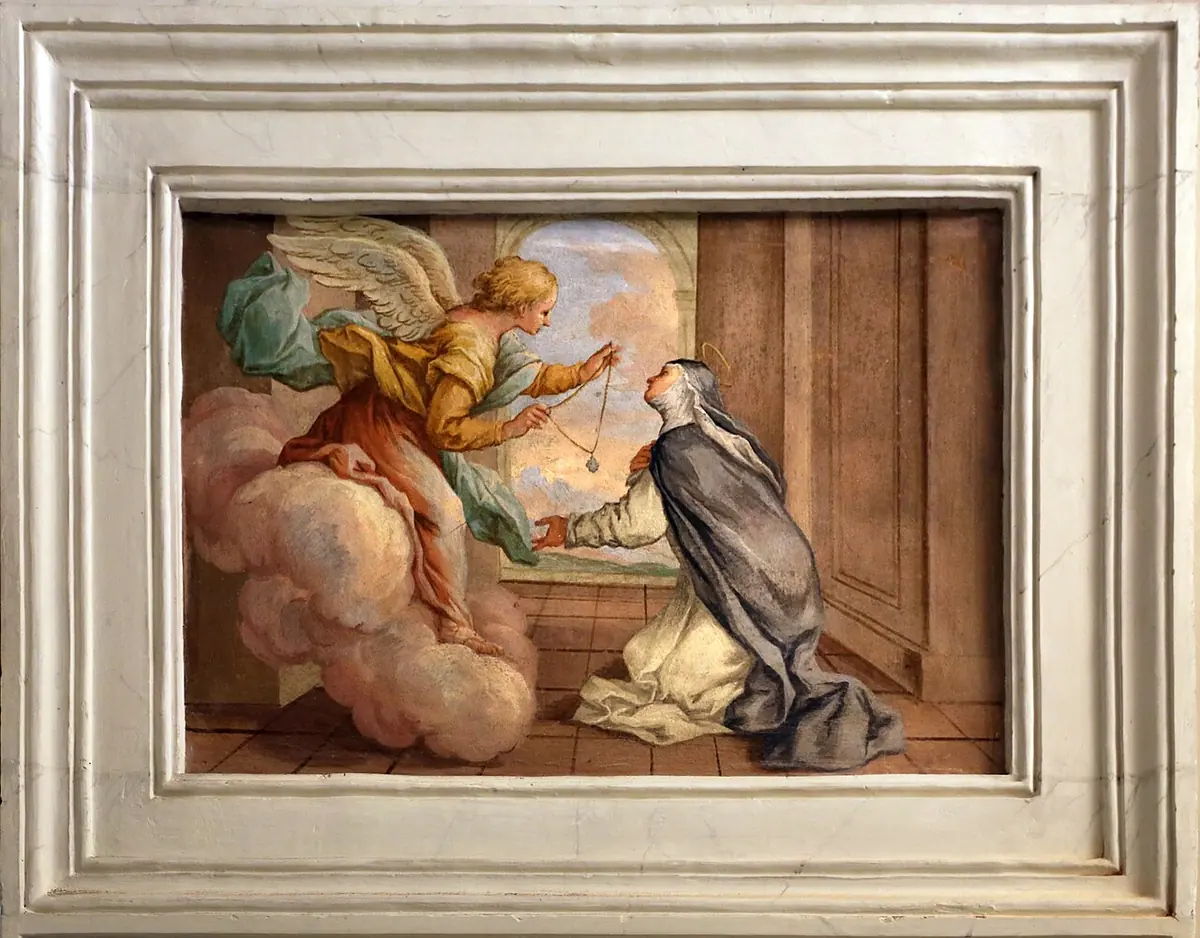 Fresco in a stucco frame of an angel in gold and blue swooping down on a cloud to hand a tiny cross on a thread to a kneeling Dominican nun at an open doorway