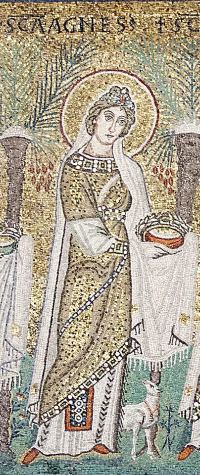 Mosaic of St. Agnes in a white and gold robe with a jeweled crown in her hands, a small white lamb at her feet and palm trees behind her, her name written above