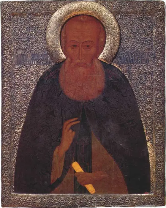 Old Russian icon of a monk with a broad gray beard and a gold halo, wearing a dark mantle and holding a rolled scroll