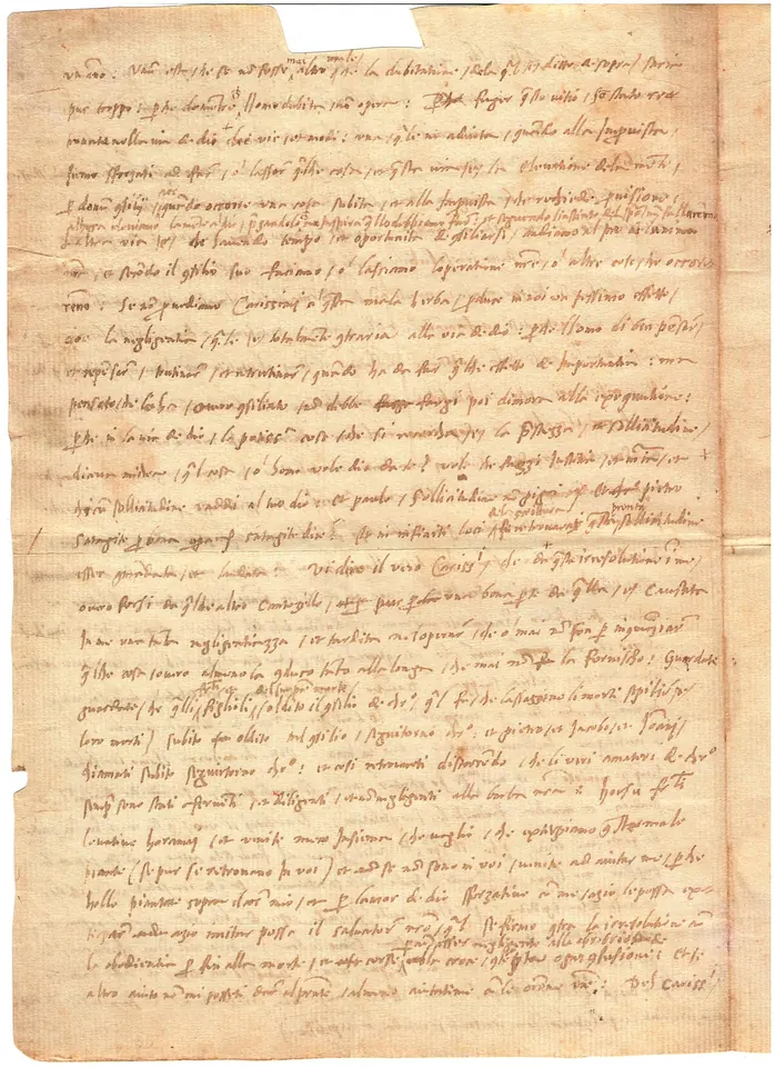 Yellowed sheet of paper covered in small sixteenth-century Italian handwriting, a letter of the saint