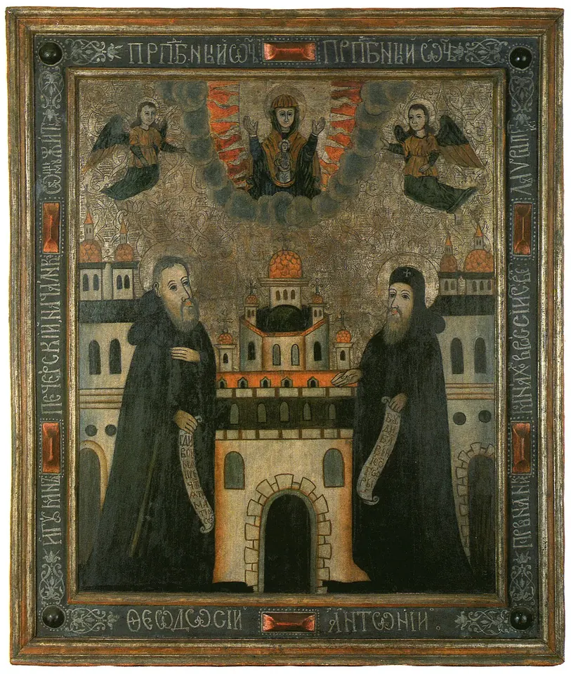 Painted icon of two monks in dark habits holding scrolls, standing on either side of a fortified monastery with a domed church, with the Mother of God and angels above them