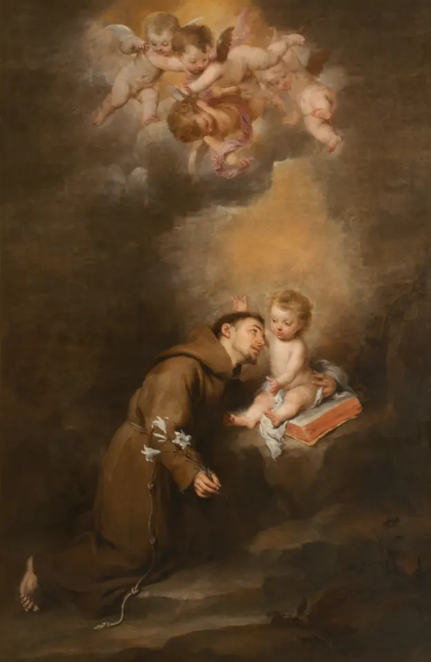 Painting of St. Anthony kneeling in a brown habit to embrace the Christ Child, who sits on an open book and points upward, with a lily on the ground and cherubs above