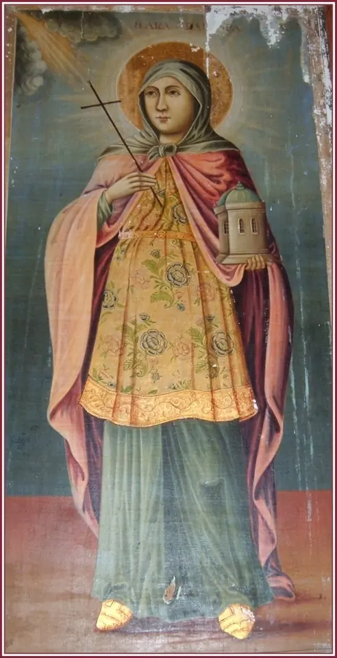 Greek icon of St. Barbara in a red cloak and green gown, holding a cross and a small tower with windows