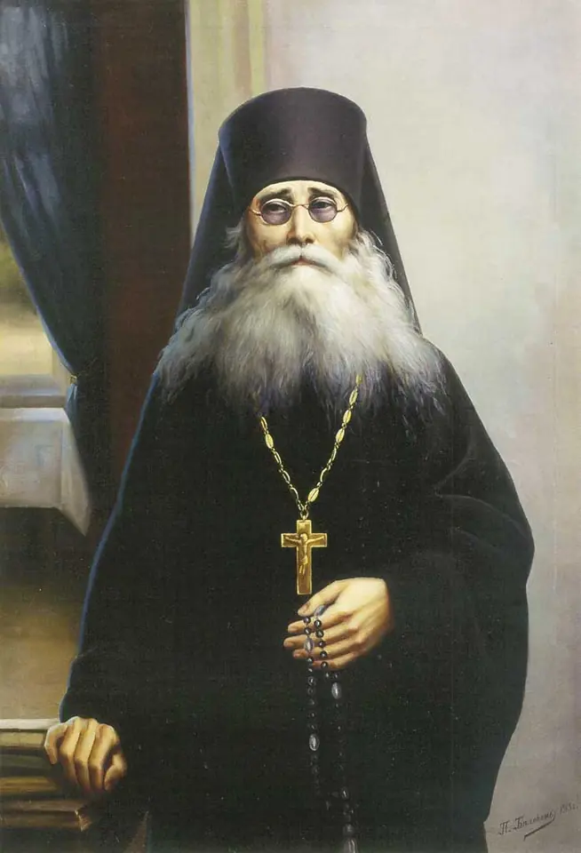 Painted portrait of an old monk with a long white beard and round spectacles, in a black cowl and robes, with a pectoral cross and a prayer rope in his hands