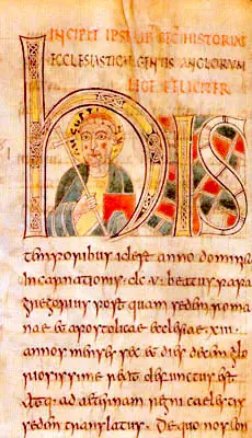 Page of an early medieval Latin manuscript with a large decorated initial H containing a small portrait of a haloed figure, above lines of brown script