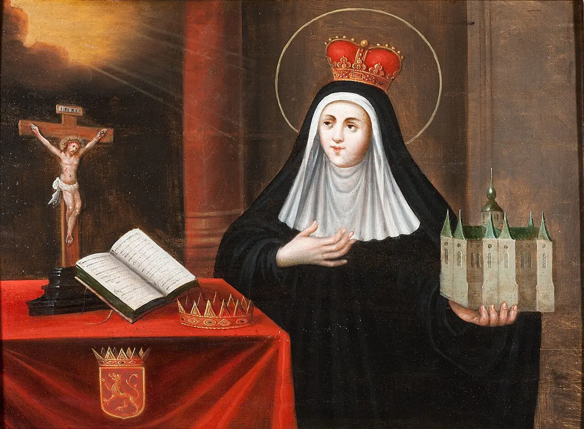 Painting of St. Begga as a crowned abbess holding a model of a church with many towers, beside a crucifix, an open book, a crown and a coat of arms on a red table