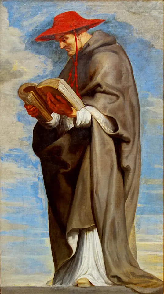 A standing friar in a brown habit and a red cardinal's hat reads a book held open in both hands against a blue sky