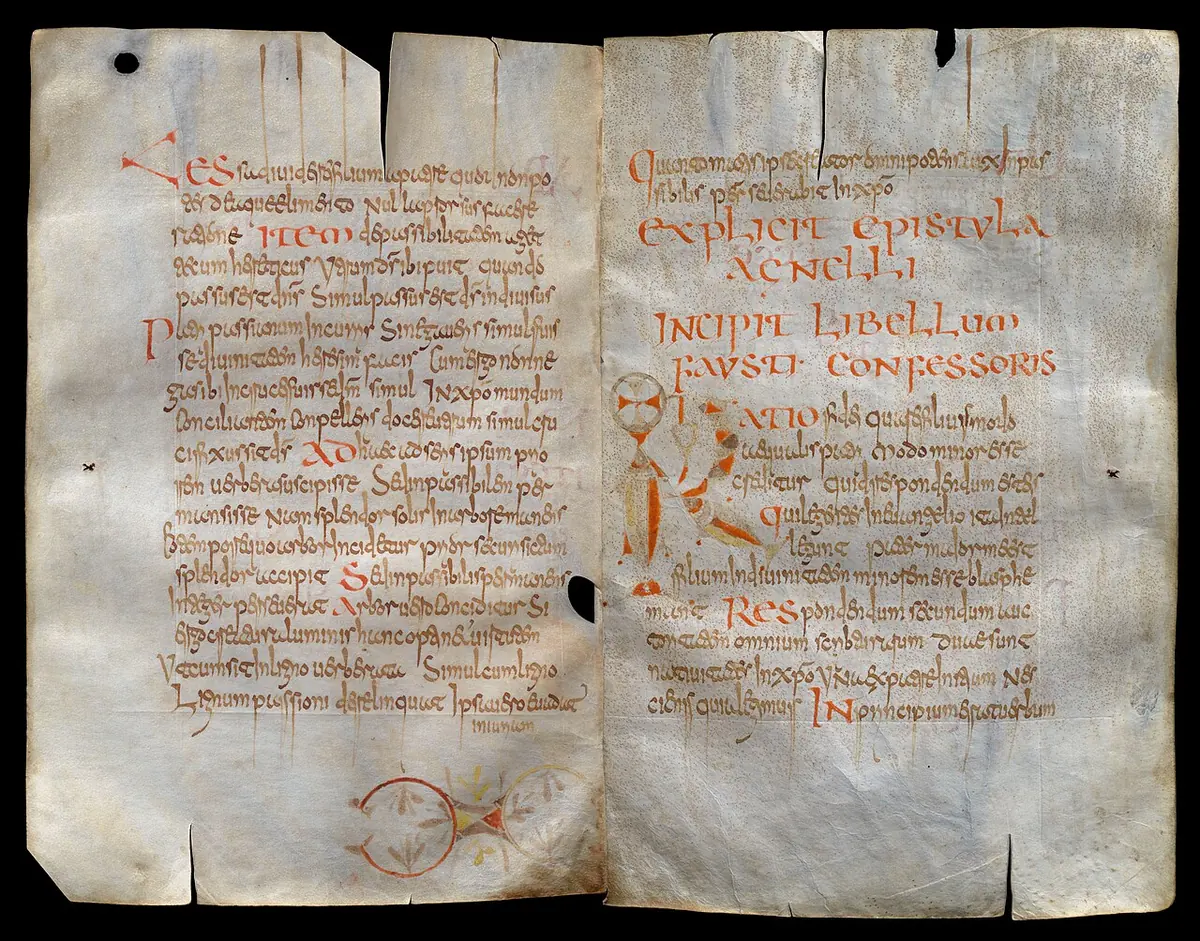 Two facing parchment pages of an early medieval manuscript written in brown ink with red initials, the edges worn and cut