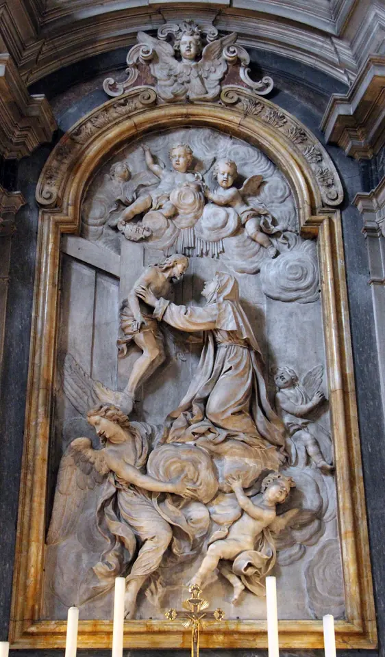 Marble altar relief of a kneeling nun embraced by Christ leaning down from the cross, with angels in clouds above and below, in a carved frame