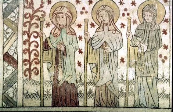 A medieval wall painting of three haloed women in veils and long robes holding tall staffs, among red and green plant patterns