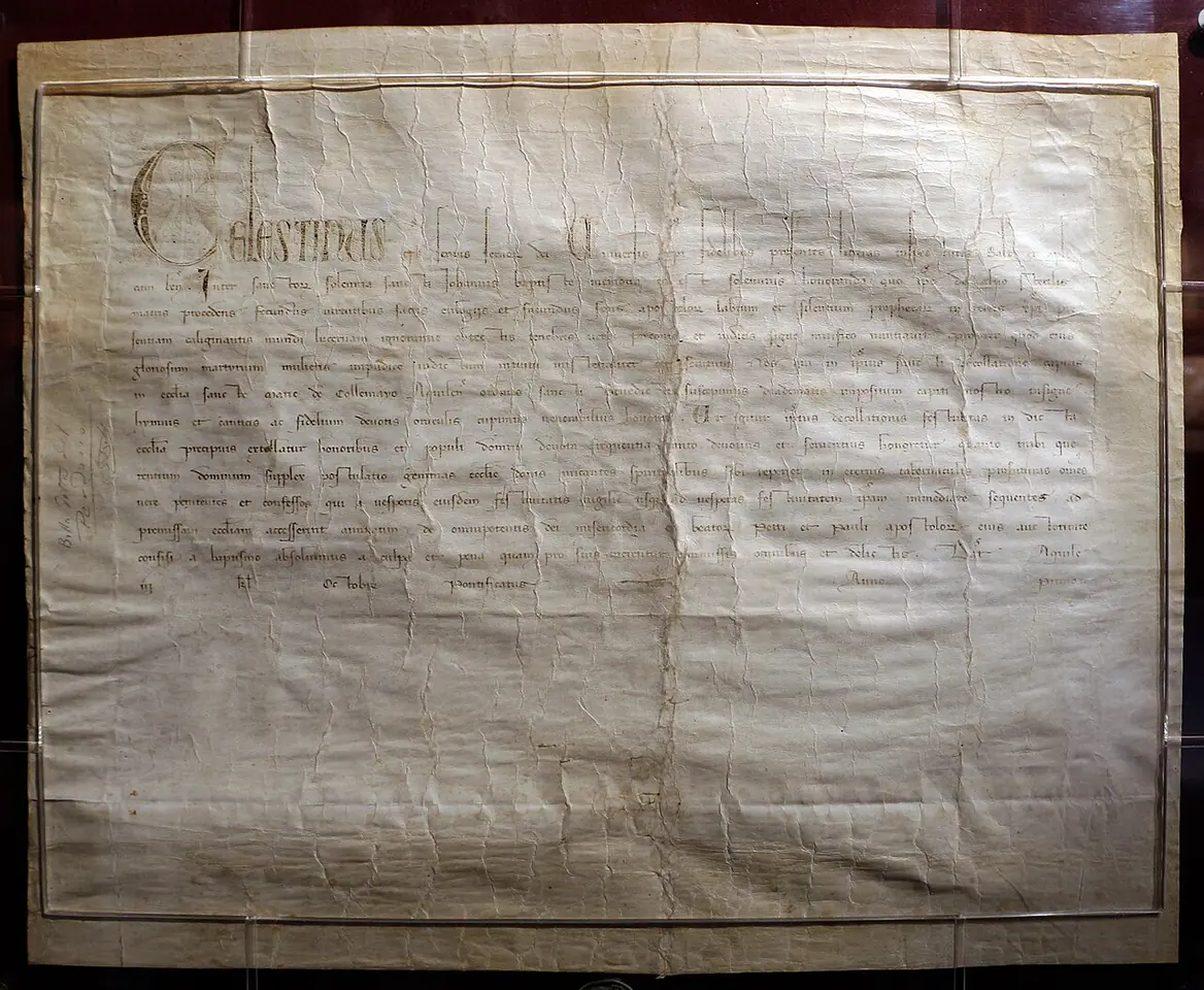 The parchment of Celestine V's Bull of Forgiveness, a wide sheet of medieval Latin script under glass