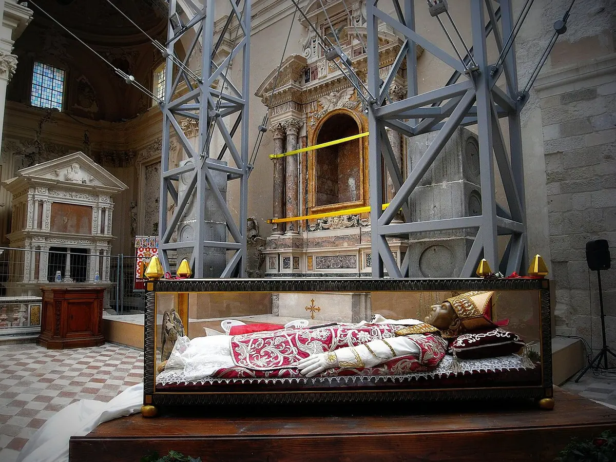 The glass casket of Celestine V inside Collemaggio basilica, surrounded by gray steel scaffolding put up after the 2009 earthquake