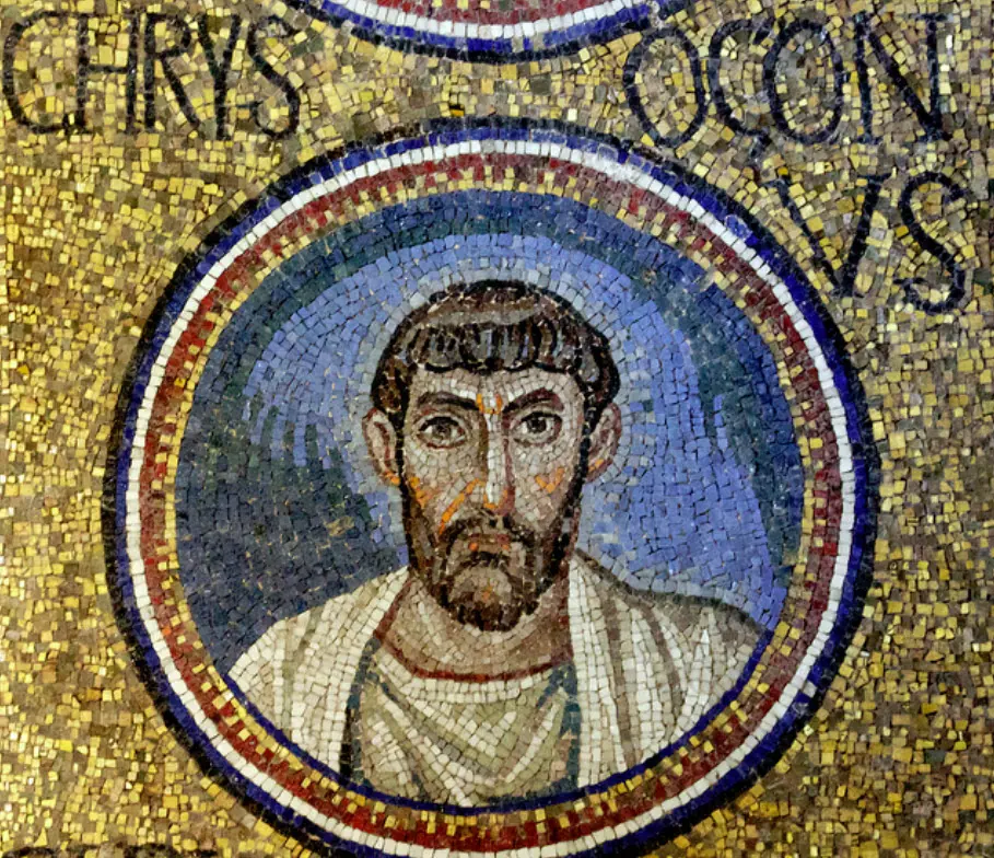 Mosaic medallion of a bearded man with dark curly hair in a white robe against a blue ground, framed in red and white rings, with the letters CHRYSOGONUS on gold above