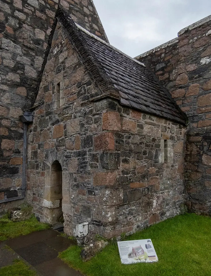 The small steep-roofed stone chapel called St. Columba's Shrine beside the west front of Iona Abbey