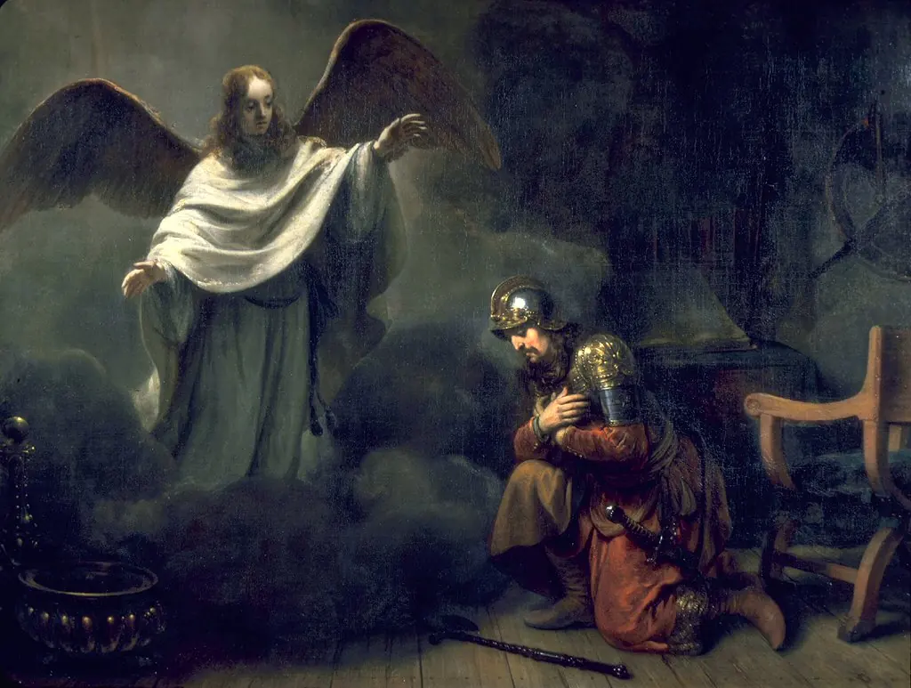 Dark interior where a radiant winged angel in white points upward while a Roman soldier in armor kneels with his hand on his chest