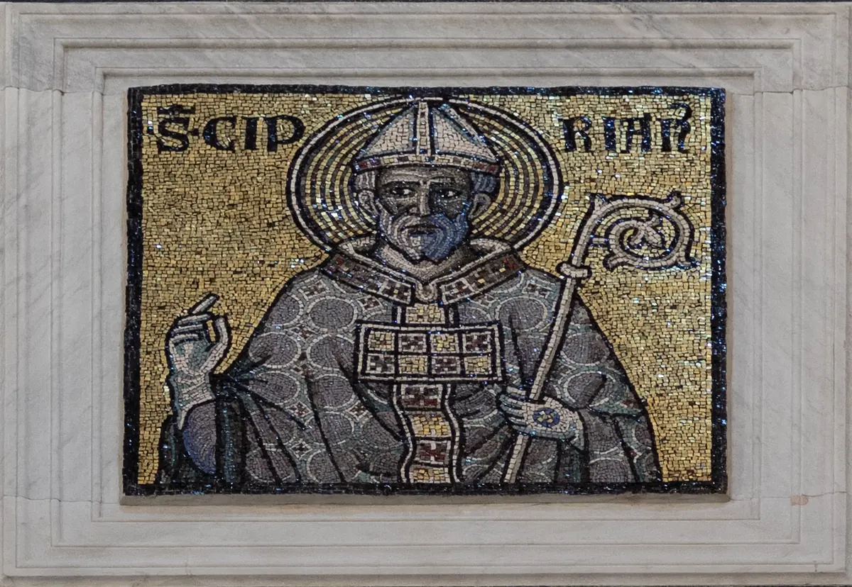 Gold-ground mosaic of a bishop in a gray chasuble and white miter, raising his right hand and holding a crozier, with the words "S. Ciprian" above