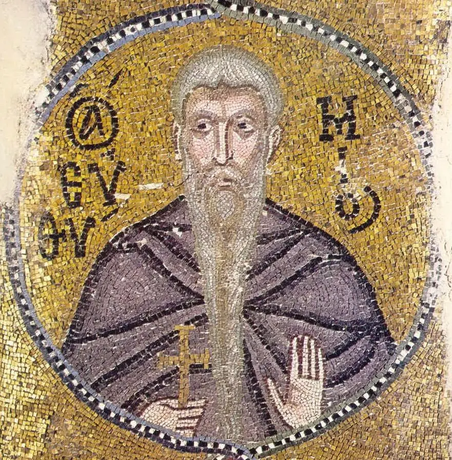 Byzantine gold-ground mosaic medallion of an old monk with a long gray beard, holding a small cross and raising his right hand, with his name in Greek letters