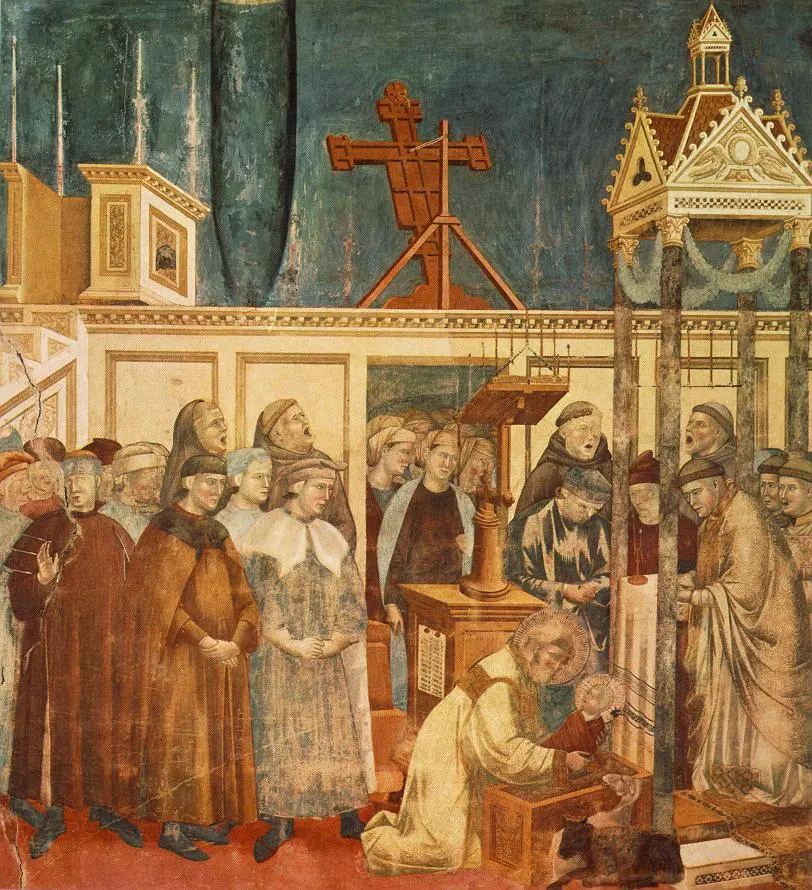 Fresco of friars singing in a church sanctuary while Francis kneels to lift the Christ Child from a manger, with an ox and a donkey beside it and townspeople watching
