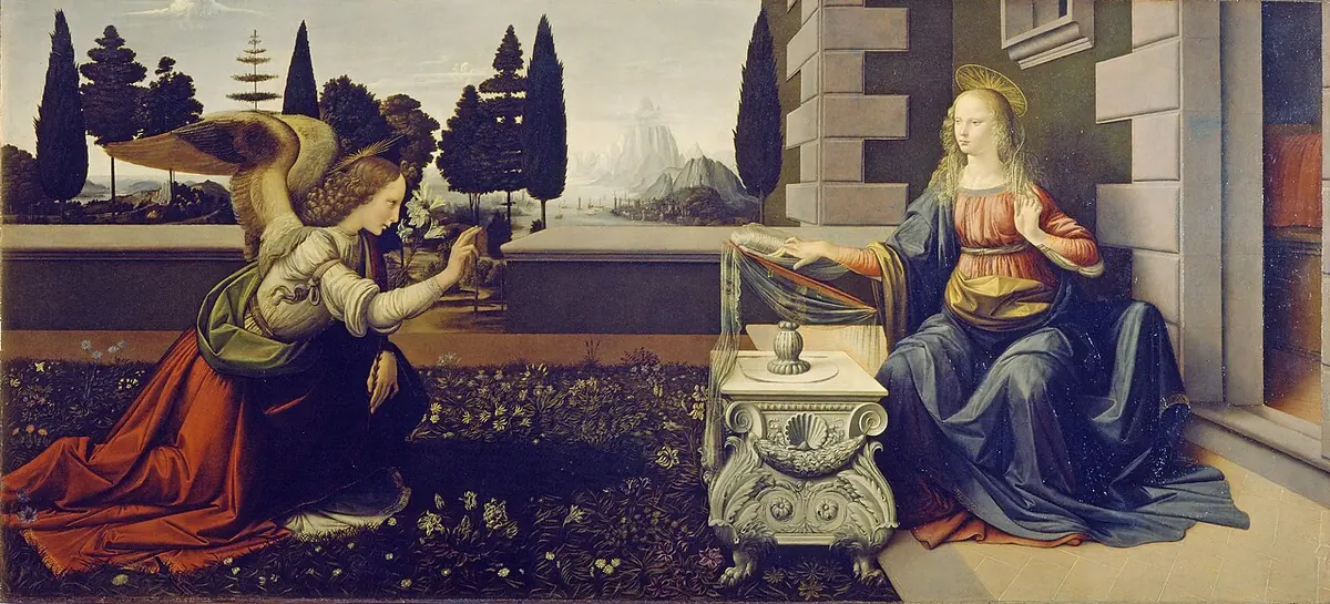 Wide painting of a kneeling angel holding a lily in a flowered garden, raising his hand to the Virgin seated at a carved stone desk before a villa, with dark trees and a misty landscape behind