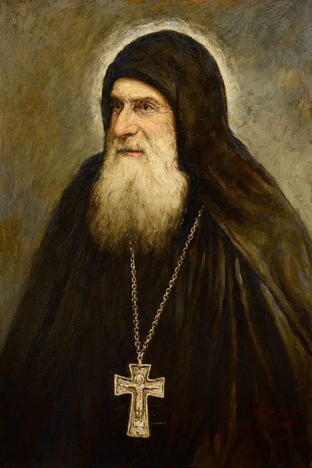 Painted portrait of an old monk with a flowing white beard in a black hood with a silver pectoral cross, his gaze turned to the side