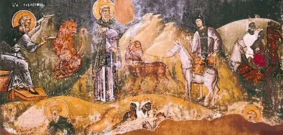 Byzantine wall painting of several scenes in a rocky landscape, with a haloed monk, a lion, and a donkey led by men with camels